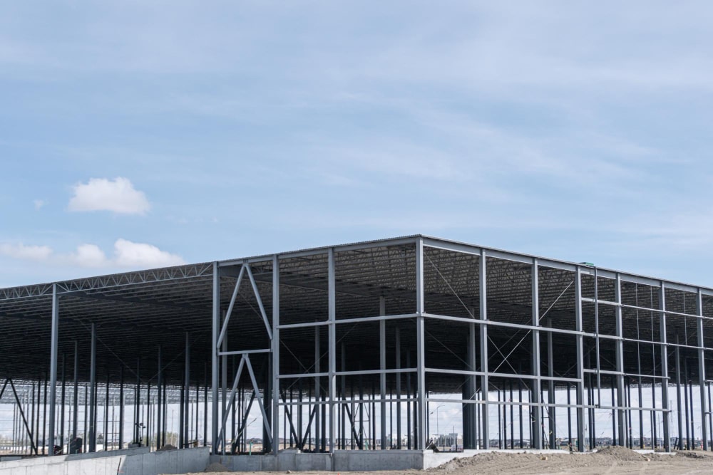 Steel frame of a large commercial building under construction, perfect for "metal buildings for sale