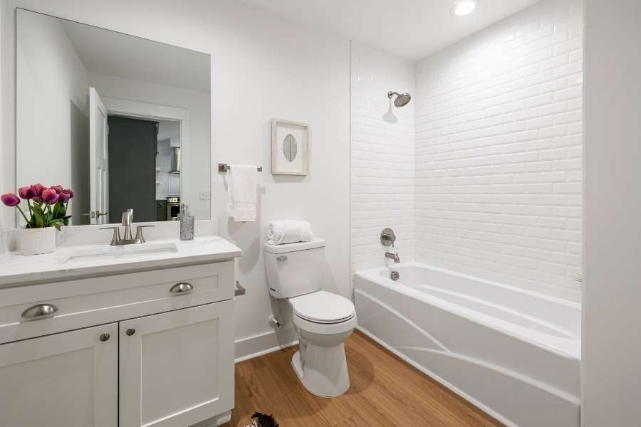 A clean and cozy home bathroom showcasing a traditional vanity sink and a metallic bathroom faucet.