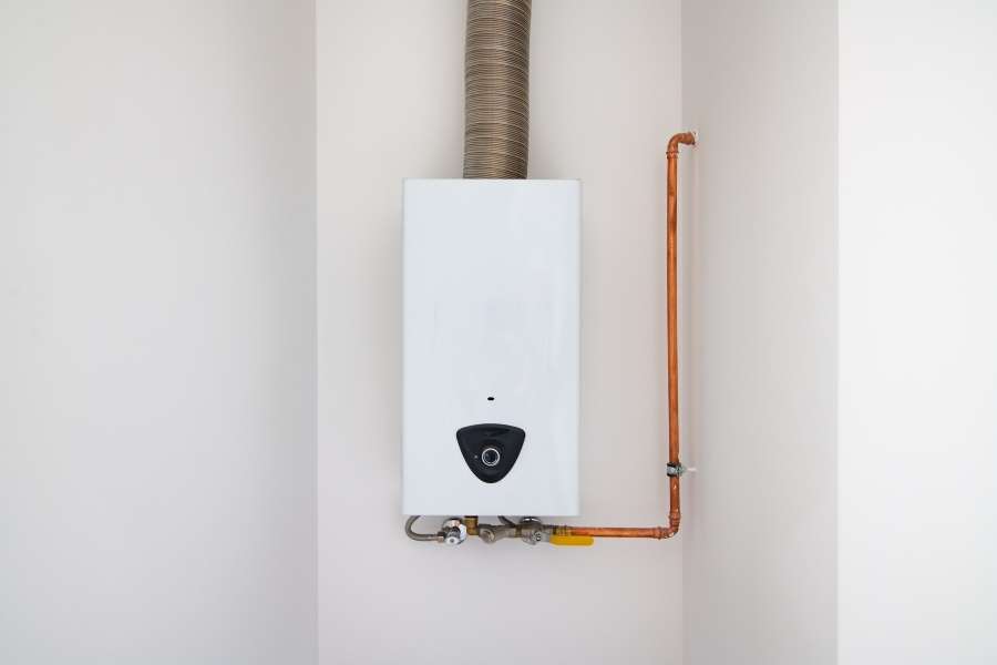 A modern white wall-mounted gas boiler representing a failing water heater.